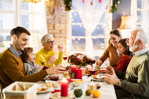 istock Happy multi-generation family enjoying in conversation during Thanksgiving lunch at dining table. 1164844767