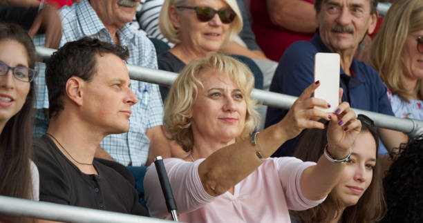 istock Woman taking selfie in stadium 1164844768