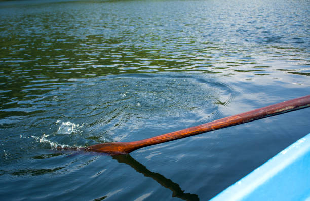 istock boat oar in the water and splashing water 1164845084