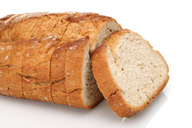 istock Sliced floury wheat bread isolated on white 1164847106