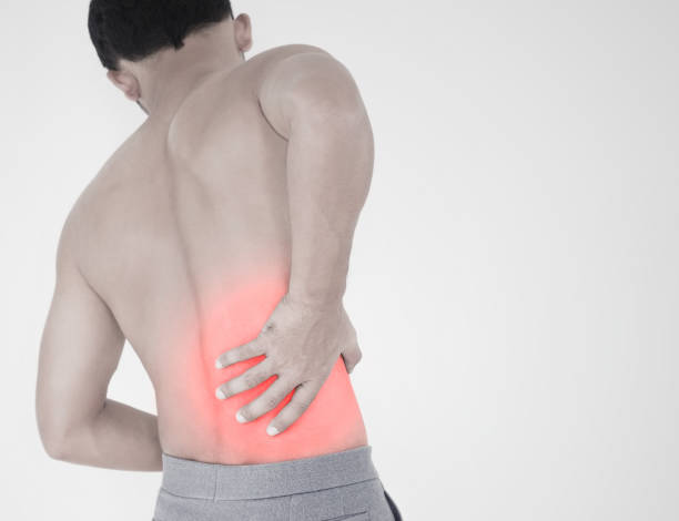 istock Portrait of young man touching him back with pained expression, suffering from backache after long working hours, Healthy concept. 1164848873