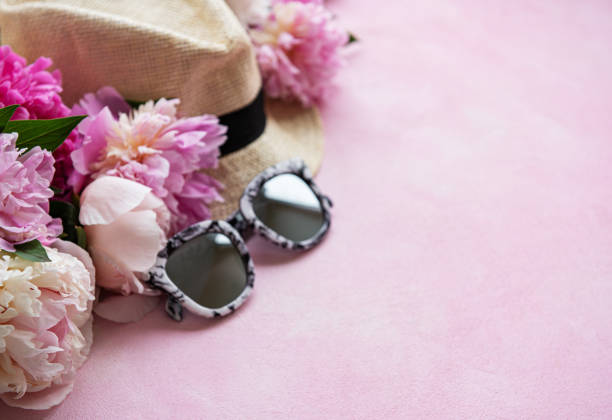 istock Pink peonies and hat on a pink concrete background 1164848948