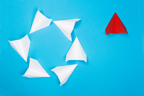 istock Red paper plane are different from others on blue background. Think different. Business for innovative, solution concepts 1164849115