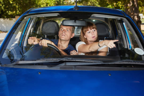 istock Young couple in car disagree about directions seeming lost 1164849898