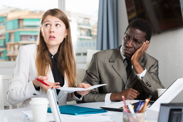 istock Upset coworkers working together 1164850803