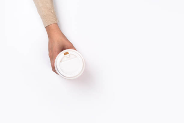 istock Female hand with paper cup isolated on white. Flat lay 1164851009