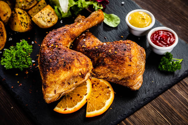 istock Fried chicken leg with fried potatoes and vegetables 1164852049