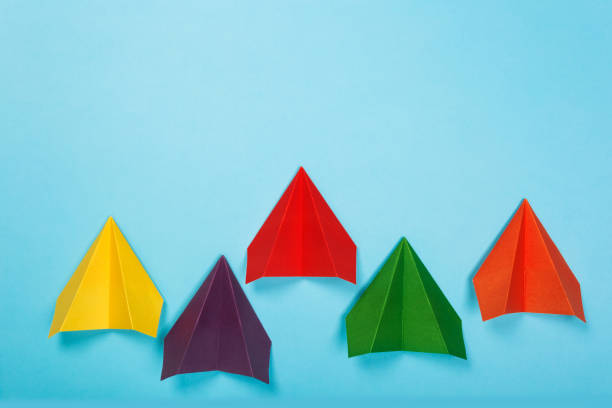 istock Color paper airplanes on blue background. top view 1164852700