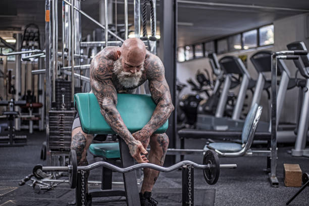 istock Tattooed Senior Man During Gym Workout 1164856245