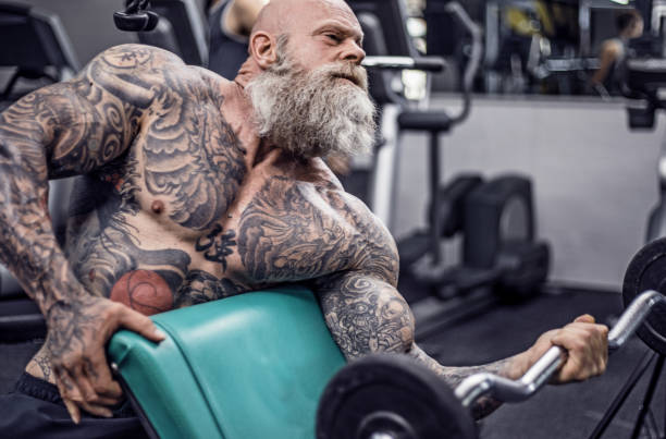 istock Tattooed Senior Man During Gym Workout 1164856669