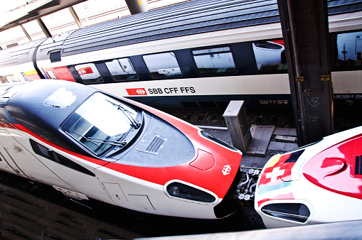 Two Swiss Federal Railways (SBB CFF FFS) owned trains (incl. a Milan-bound high speed train) on the platforms of Basel BFF Bahnhof (aka Basel train station) in Switzerland.