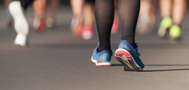 istock Runners feet running on road 1164858548