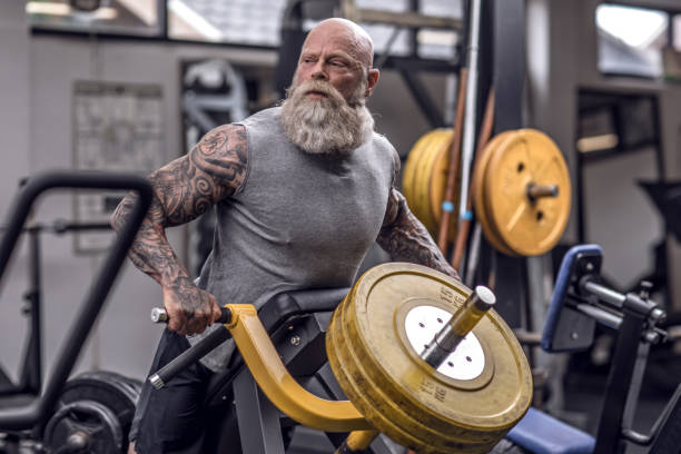 istock Tattooed Senior Man During Gym Workout 1164858836