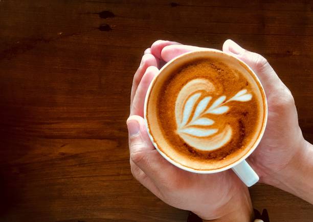 istock Cropped Hands Of Person Holding Coffee Cup On Table 1164861963