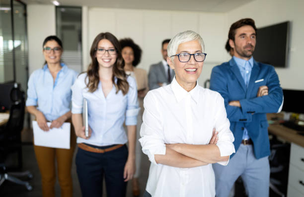 istock Group of successful business people at work in office 1164862080