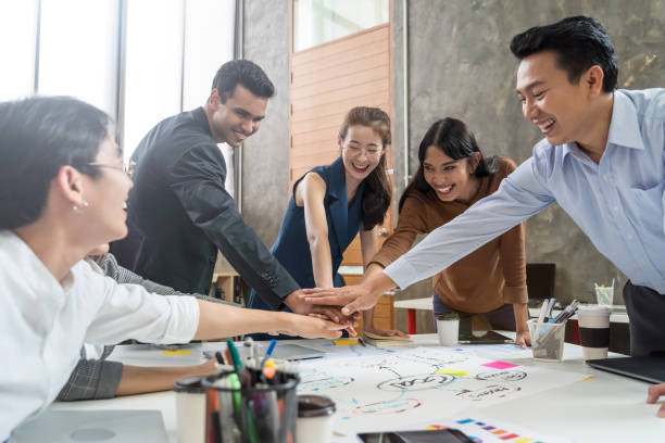 Group of Asian team creative business people join hands partnership teamwork concept