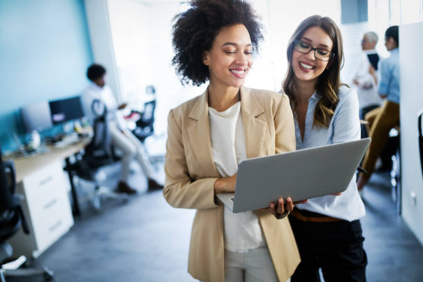 istock Group of successful business people at work in office 1164862607