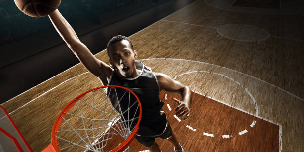istock African american basketball player makes a basket. Slam dunk. High-angle shot. 1164862930