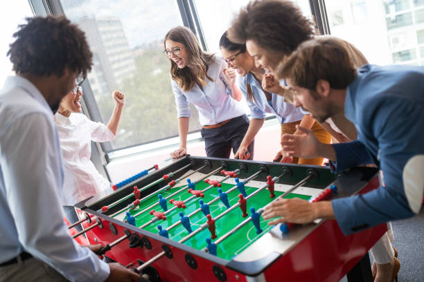 istock Colleagues playing table football in the break. 1164863088
