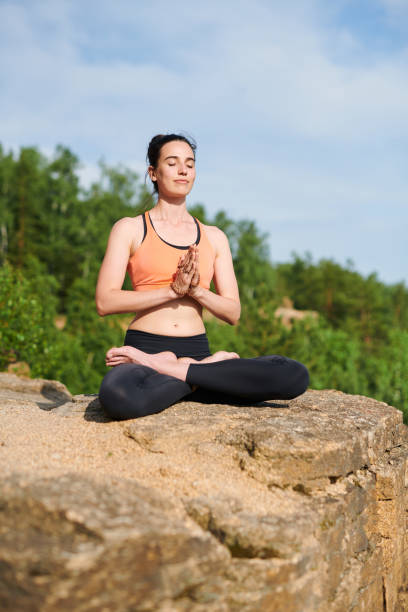 istock Calm peaceful lady in lotus pose 1164863922