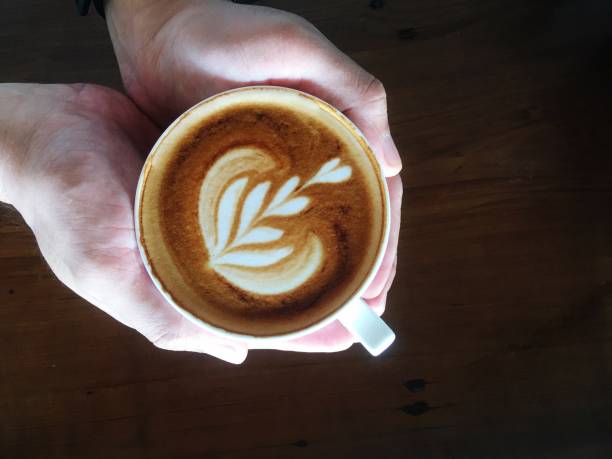 istock Cropped Hands Of Person Holding Coffee Cup On Table 1164864607