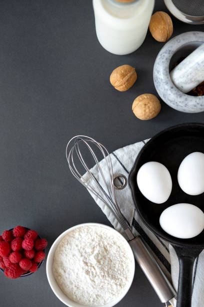 istock Baking Cake Ingredients Laid Out On A Dark Background 1164865763