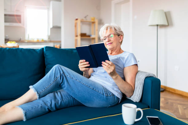istock Senior Woman With Book at Home 1164866209