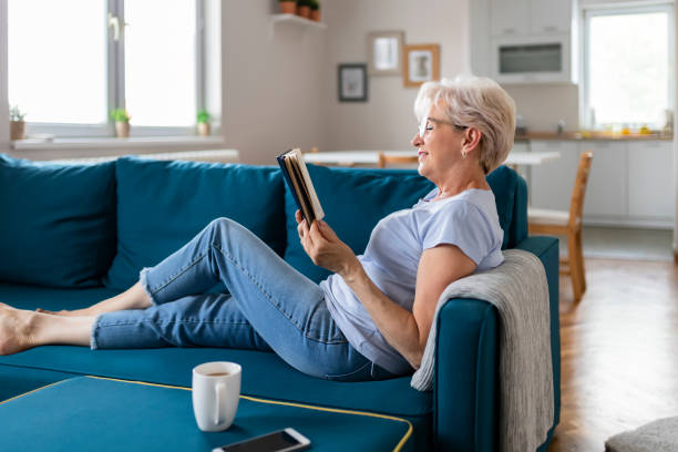 istock Senior Woman With Book at Home 1164866476