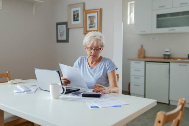 istock Senior Woman Online Banking While Planning Her Home Budget 1164867771