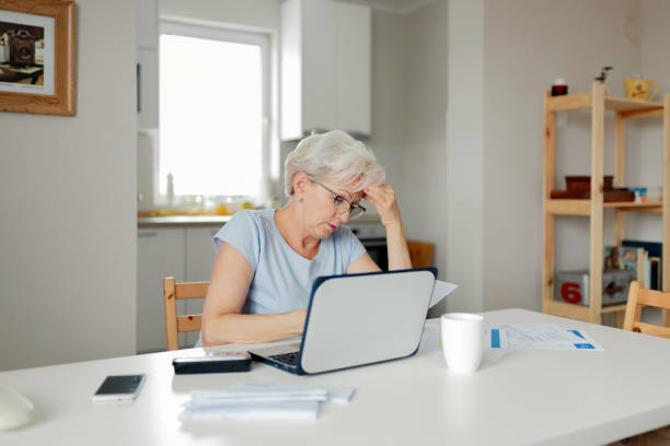 istock Senior Woman Online Banking While Planning Her Home Budget 1164867837