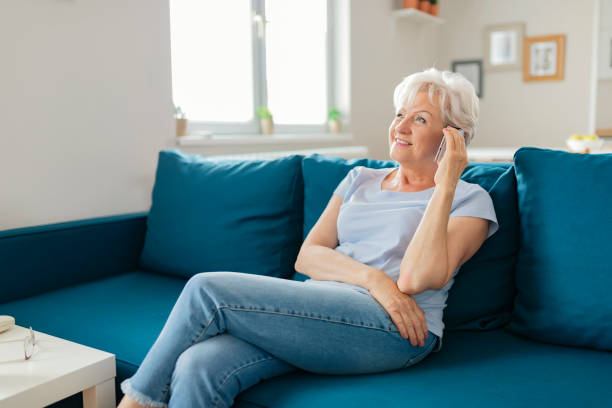 istock Smiling Senior Woman Using Mobile Phone 1164867882