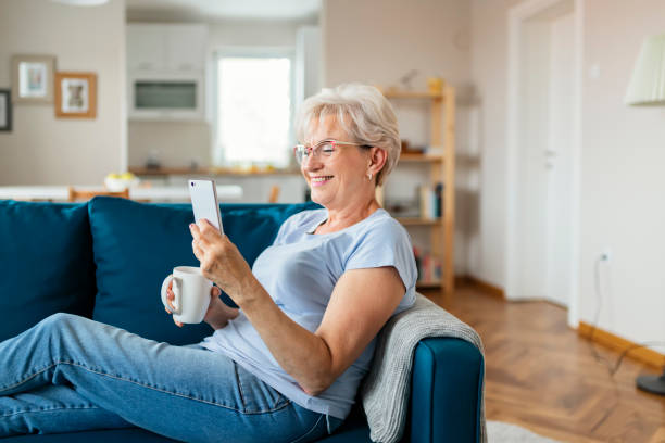 istock Smiling Senior Woman Using Mobile Phone 1164868002