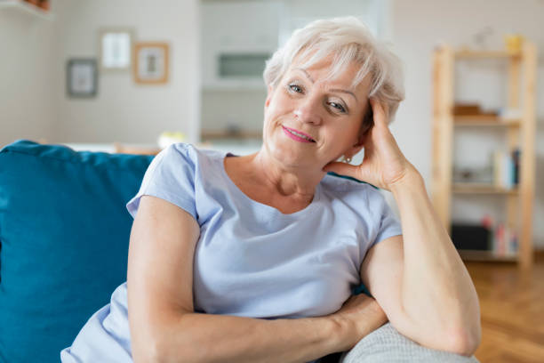 istock Happy Senior Woman on Couch 1164868005