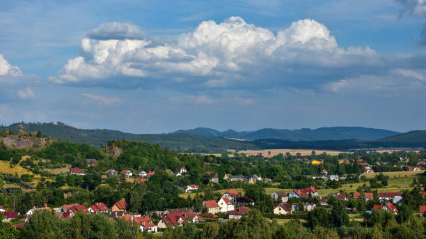 istock Clouds over a small town in the mountains 1164869036