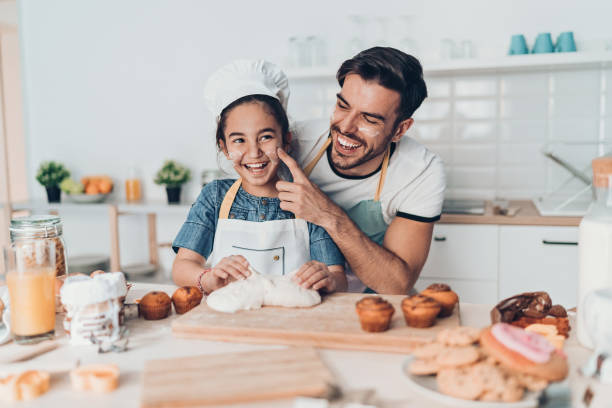 istock Father and daughter playing in the kitchen 1164869638