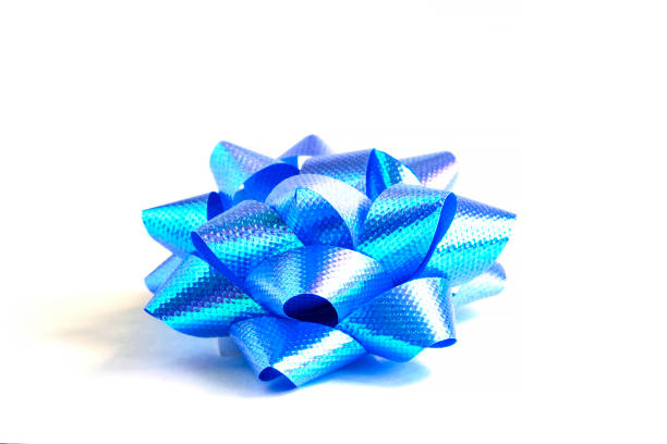 istock Close-up of decorative blue gift bow on white background 1164873388