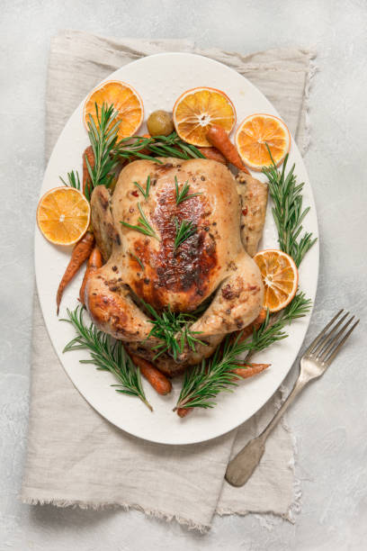 istock Traditional roasted turkey with rosemary on light table. Top view. 1164875215