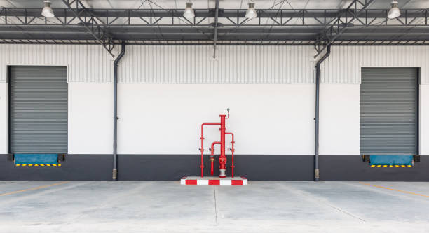 istock Shutter door or roller door and concrete floor outside factory for loading and unloading goods in industry. Industrial concept 1164876061