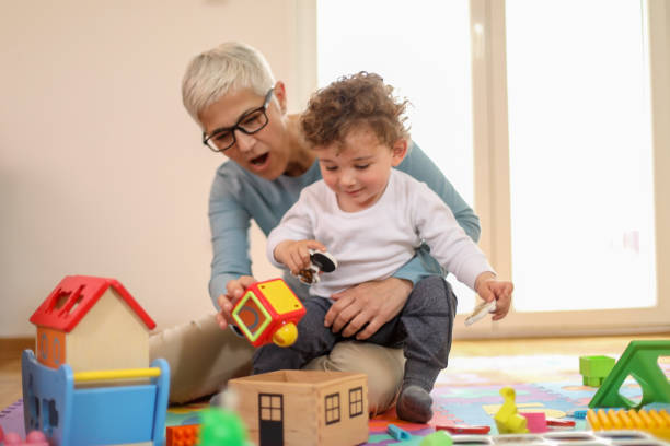 istock Grandmother playing with her grandson 1164877061