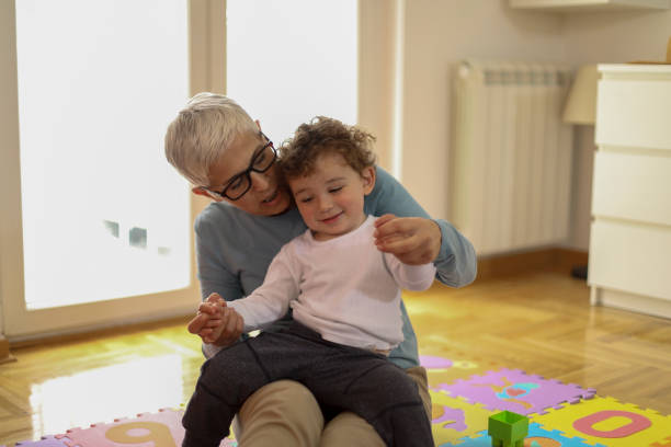 istock Grandmother playing with her grandson 1164877077