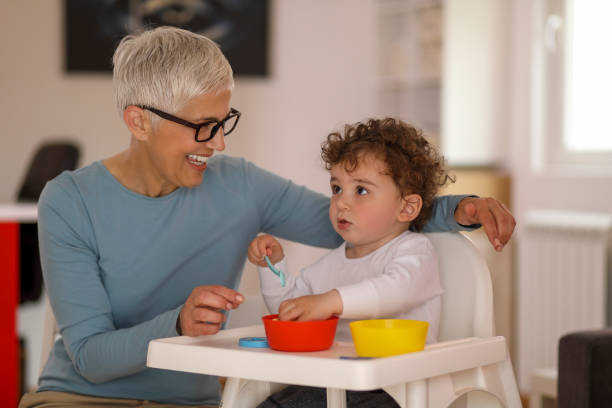 istock Grandmother feeding her grandson 1164877599
