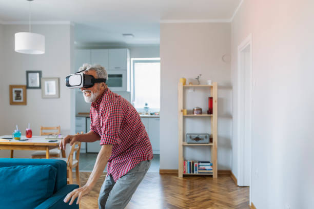 istock Senior old man eldery enjoy playing game with VR Virtual Reality 1164878431
