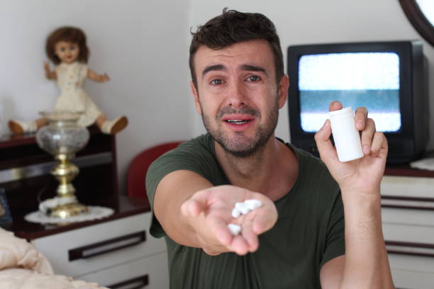 istock Emotional man holding some pills 1164878587