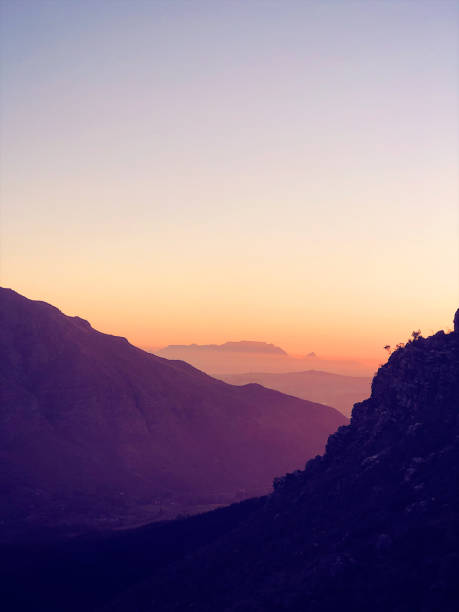 Table Mountain from Stellenbosch Mountains during dusk A unique view of Table Mountain from Stellenbosch Mountains at sunset Stellenbosch Cape Town South Africa beauty in nature vertical africa southern africa stock pictures, royalty-free photos & images