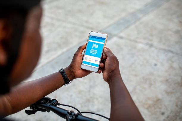 istock Senior African Delivery Man Checking Mobile App For Delivery 1164880094