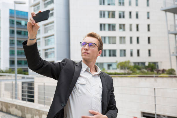 istock Pensive calm businessman taking selfie 1164881108
