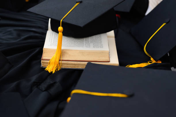 istock Hat of black graduates and books on the table 1164881505