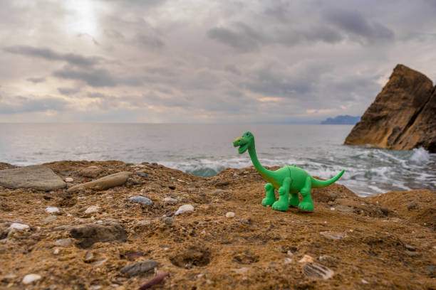 istock Toy dinosaur on the sea 1164881610