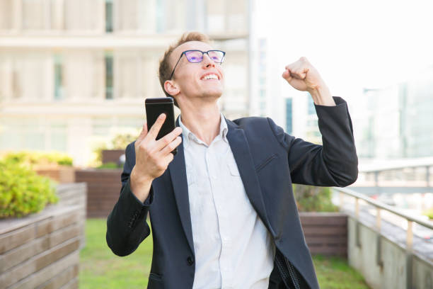 istock Happy excited manager with smartphone thanking god 1164882498