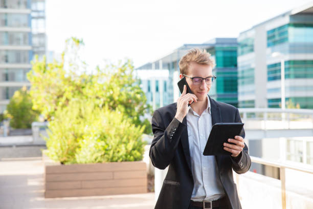 istock Smiling satisfied manager talking on phone 1164882564